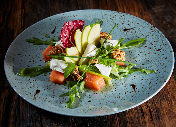 Green salad with roast squash, pomegranate, and nuts