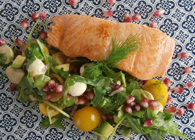 Roast salmon with rocket, avocado, and pomegranate sauce 